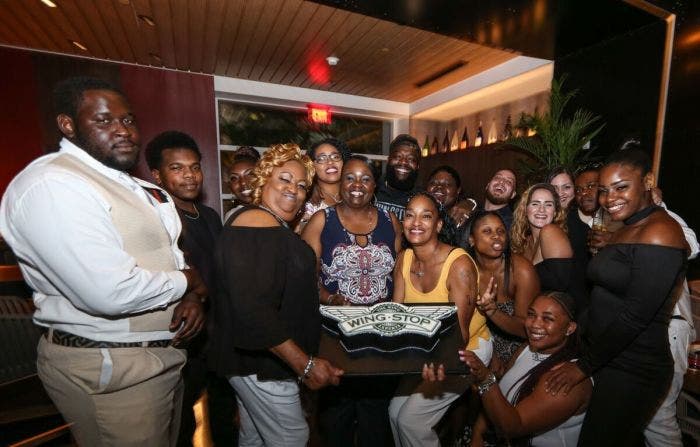 Rick Ross celebrates another sales milestone with Wingstop staff