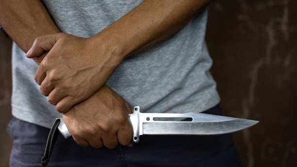Criminal or bandit holding a knife.