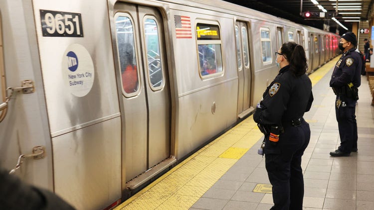 NYPD officers patrol the subway