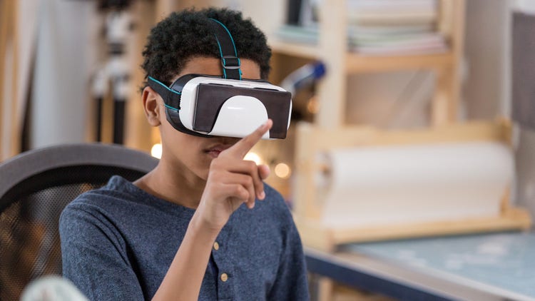 boy plays virtual reality game