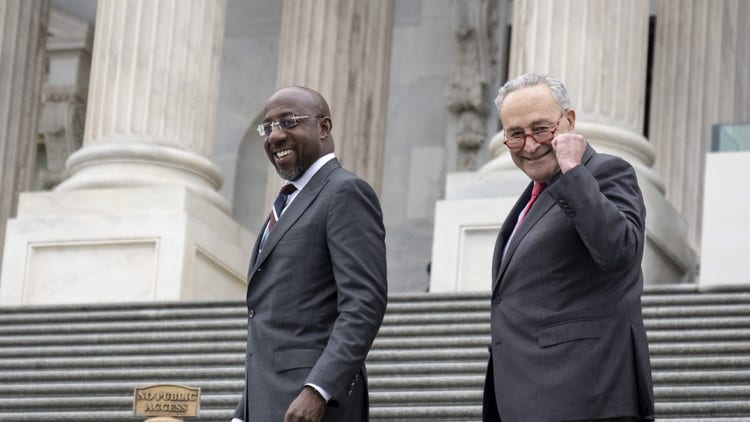 Senate Majority Leader Chuck Schumer and Sen. Raphael Warnock