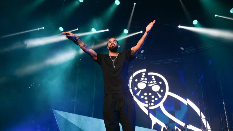 Drake performing in front of an OVO logo