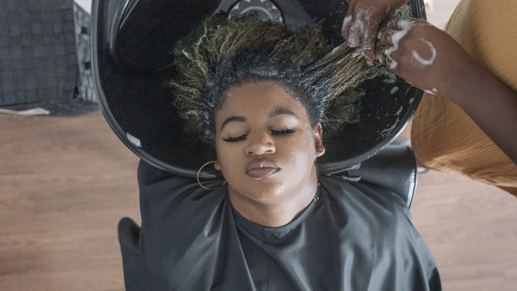 Black woman getting her hair washed