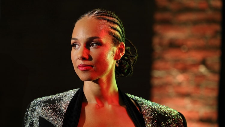 A person with braided hair Description automatically generated