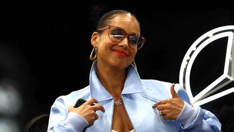 A person wearing glasses and a blue jacket Description automatically generated
