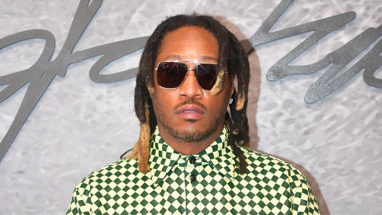A person with dreadlocks wearing sunglasses Description automatically generated