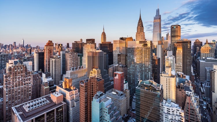 A city skyline with tall buildings Description automatically generated