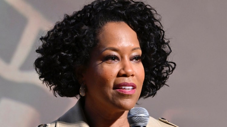 A person with curly black hair Description automatically generated