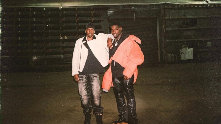 A couple of men posing for a picture Description automatically generated
