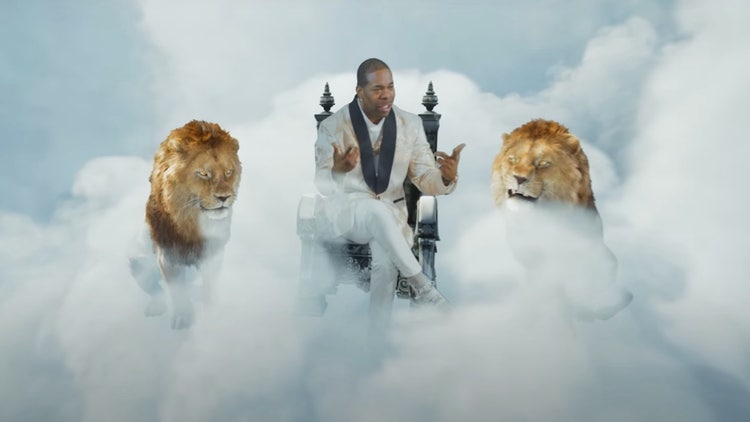 A person sitting on a chair with two lions in the clouds Description automatically generated