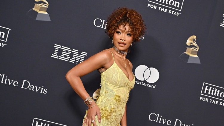 A person in a yellow dress Description automatically generated