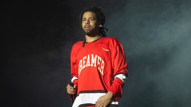 A person in a red jersey Description automatically generated
