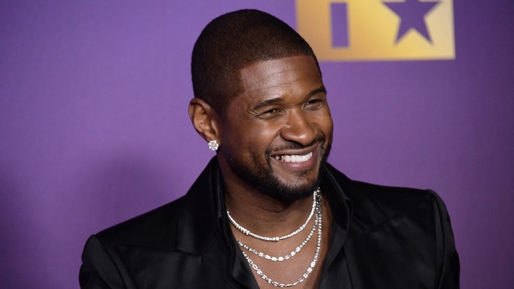 A person smiling with a necklace Description automatically generated